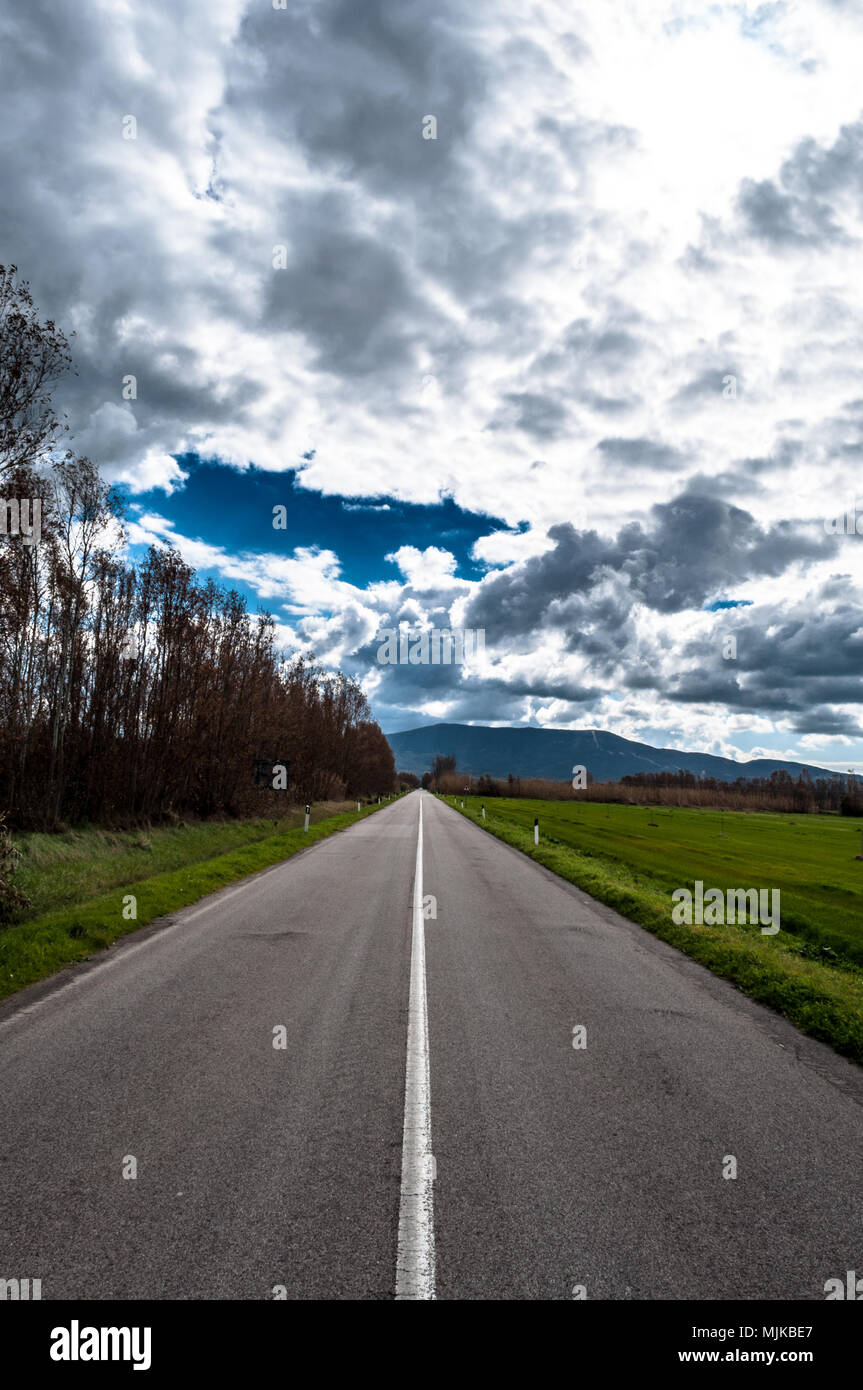 Desert country road under dramatic cloudy sky in spring noon Stock ...
