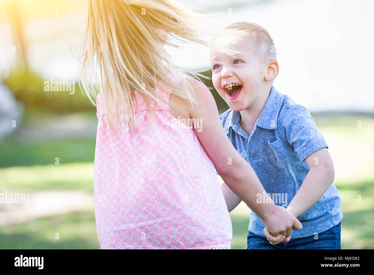 Young Brother and Sister Playing At The Park Togther Stock Photo - Alamy