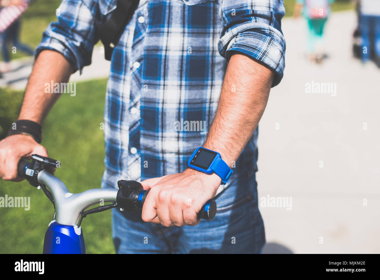 BUCHAREST, ROMANIA, - October 26, 2017: Person using smart watch and a smartphone walking on the park in a sunday. Woman making gestures on a wearable Stock Photo