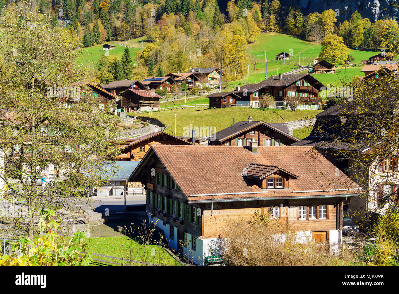 Traditional Chalets of village in Lauterbrunnen Valley at autumn ...