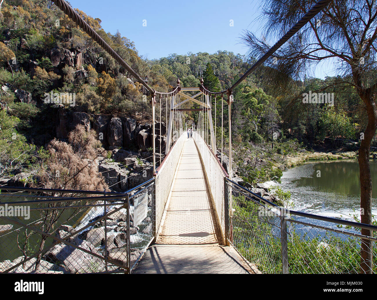Launceston, Tasmania, Australia: March 31, 2018: Tourists cross the footbridge over the South Esk River at Cataract Gorge. The area is a national park Stock Photo