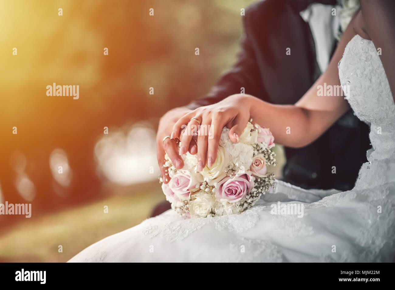 Wedding couple sitting on bench hi-res stock photography and images - Alamy