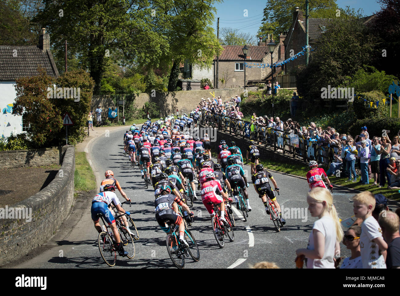Competitors ride through Great Crakehall during day three of the Tour de Yorkshire from Richmond to Scarborough. Stock Photo