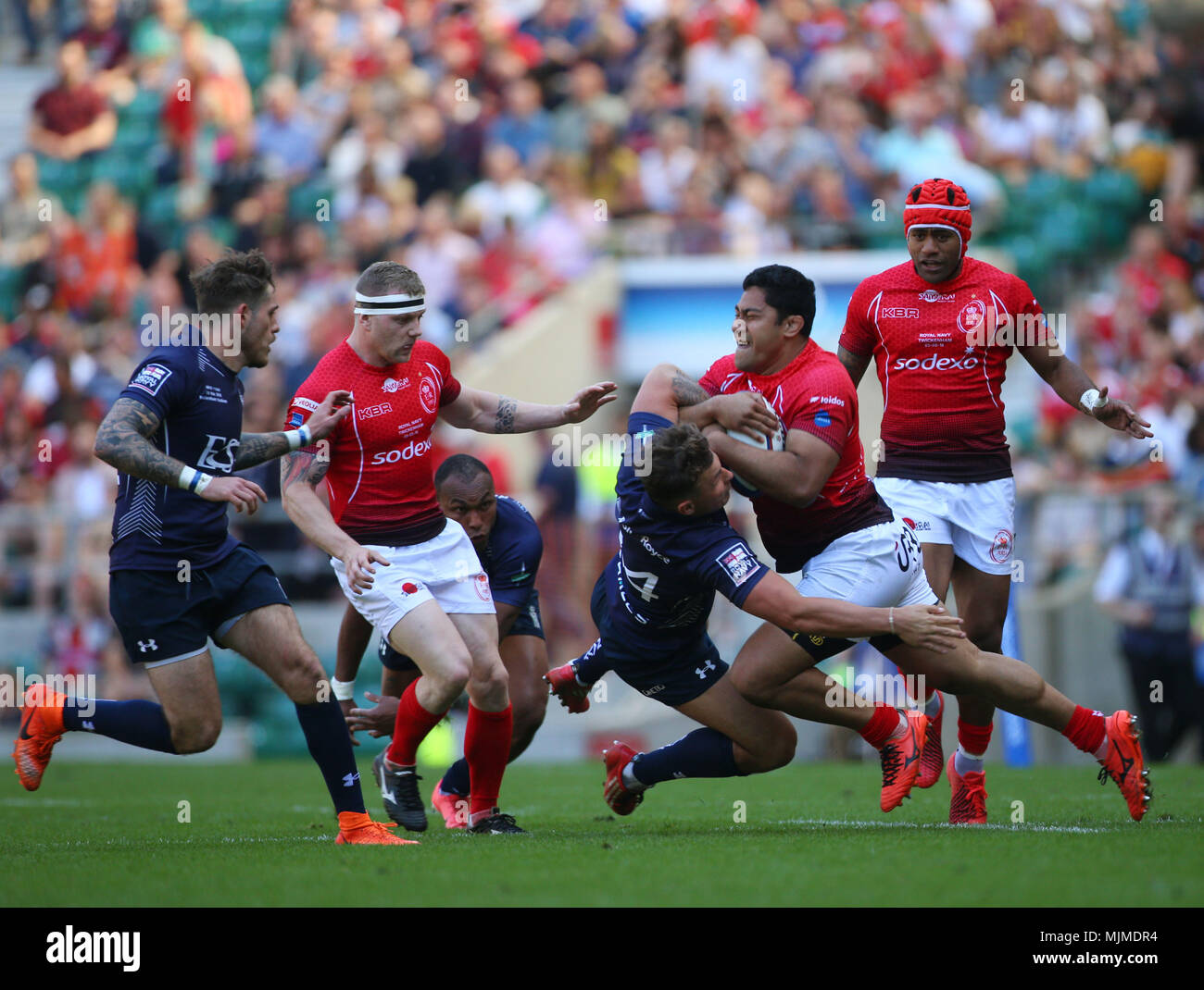 Ravai Fatiaki (2nd right) of The British Army powers through a tackle during the Babcock Trophy match at Twickenham Stadium, London. Stock Photo