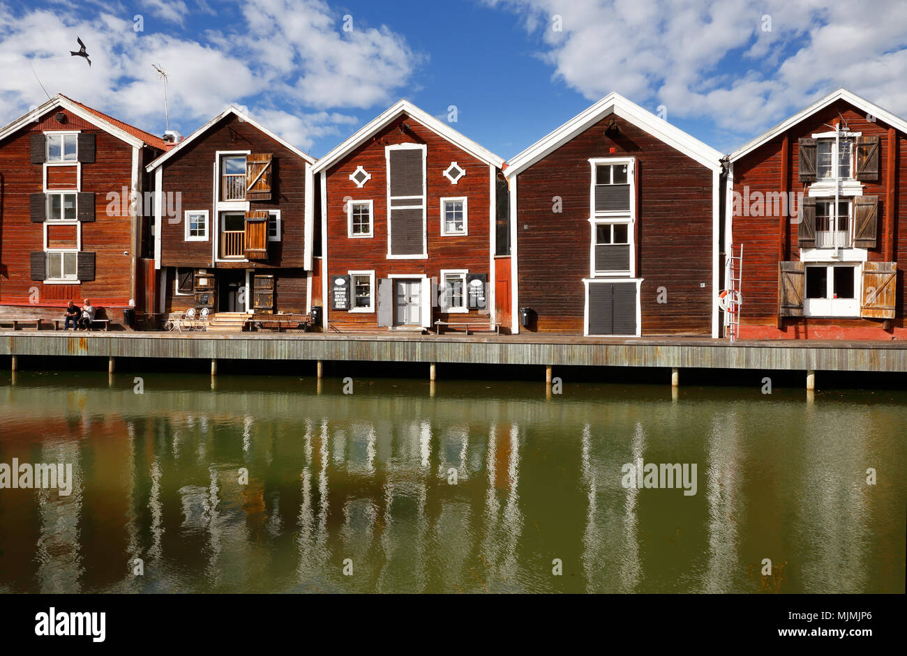 Hudiksvall, Sweden - July 5, 2017: Old red warehouses built of wood next to the water. Stock Photo