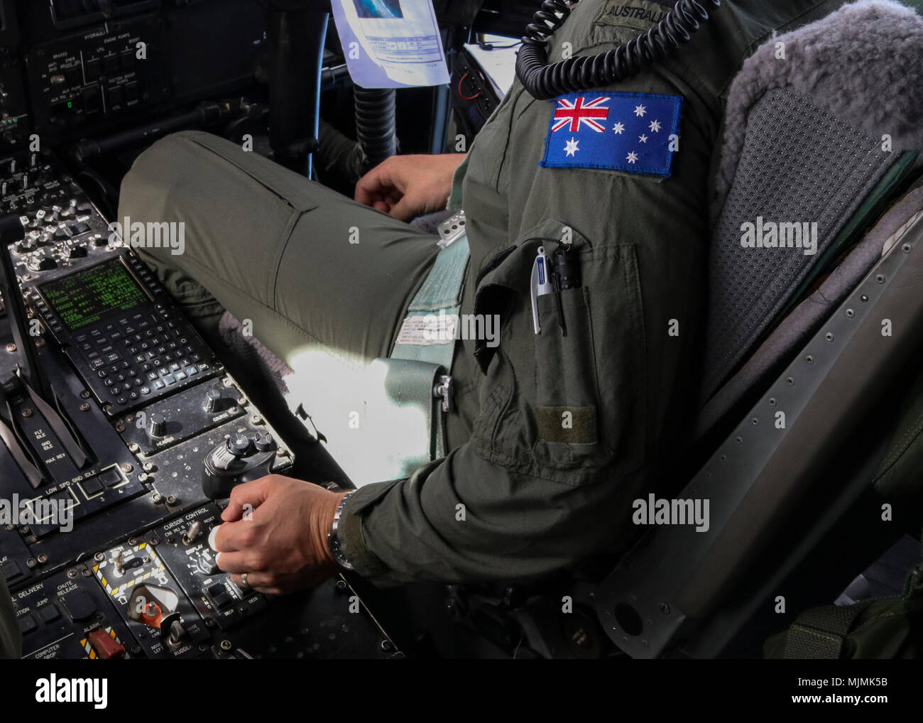 Royal Australian Air Force Flight Lt. Russel Withers, 37th Squadron pilot, adjusts the direction