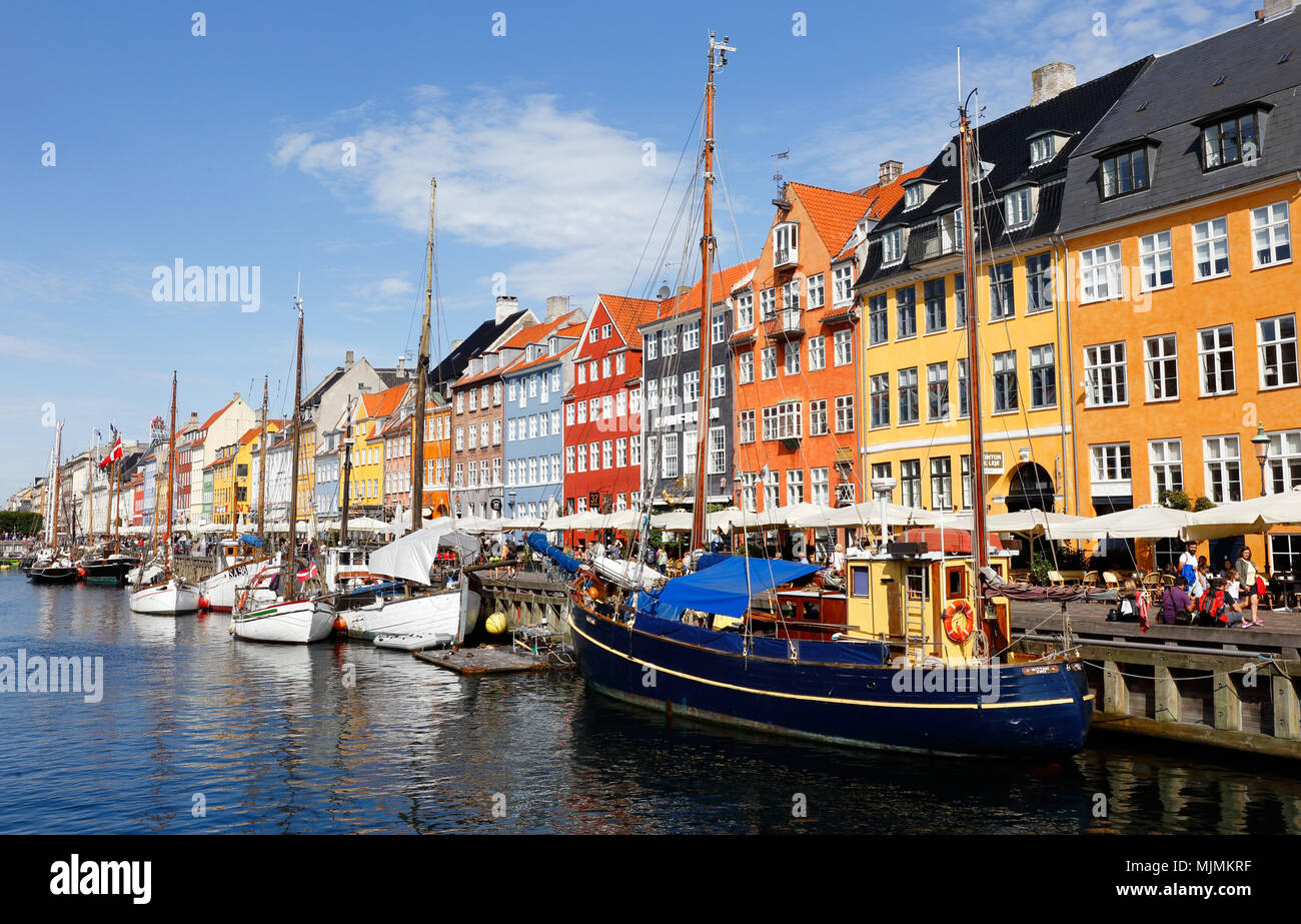 Copenhagen, Denmark - August 24, 2017: View of the tourist attraction area Nyhavn with restaurants and colorful buildings at the waterfront with old b Stock Photo