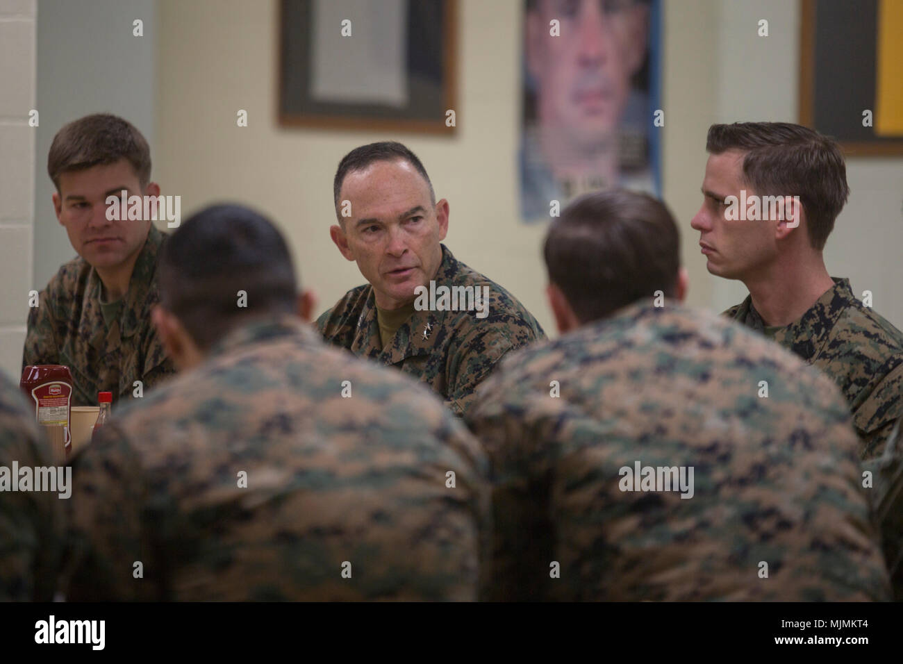 Maj. Gen. John Love speaks with Marines and sailors at breakfast during his visit with 2nd Battalion, 8th Marine Regiment during the unit’s deployment for training exercise at Fort A.P. Hill, Va., Dec. 5, 2017. The visit allowed Love to observe the battalion’s readiness for an upcoming deployment to Japan. Love is the commanding general of 2nd Marine Division. (U.S. Marine Corps photo by Lance Cpl. Ashley McLaughlin) Stock Photo