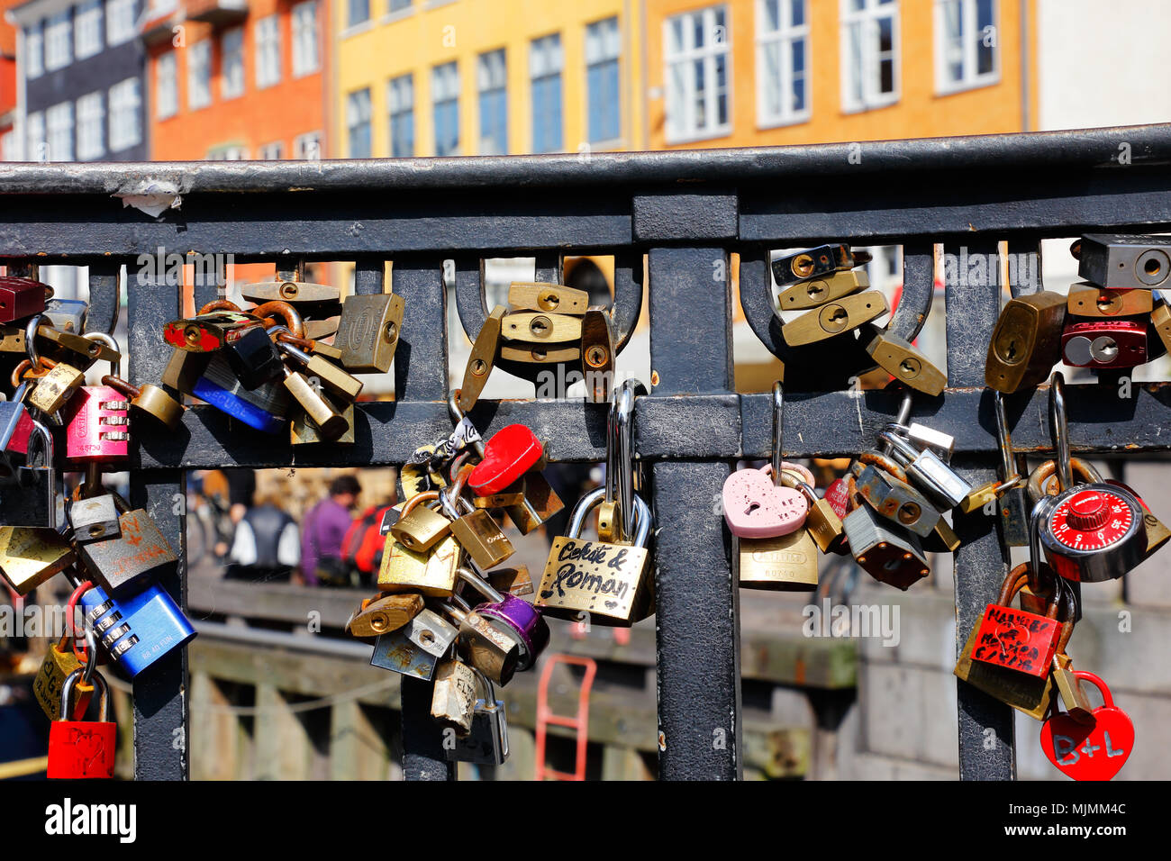 Copenhagen, Denmark - August 24, 2017: In the handrail at the bridge Nyhavnsbroen in Nyhavn, there are locked padlocks as a symbol of love. Stock Photo