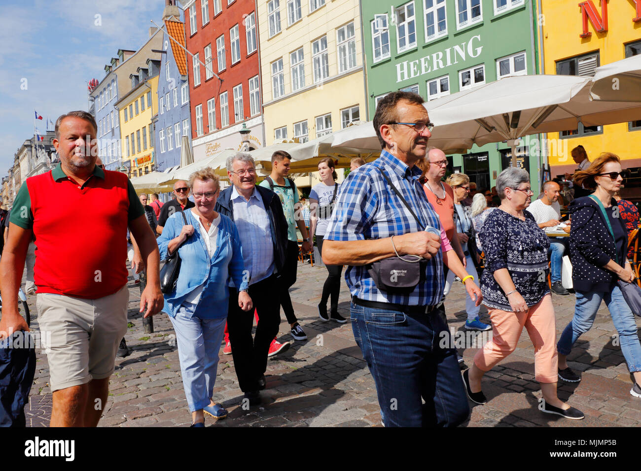 Copenhagen, Denmark - August 24, 2017: People walking in sunshine in Nyhavn. Stock Photo