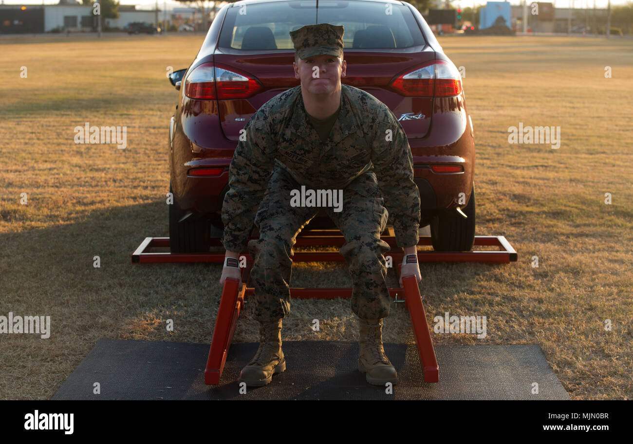 U.S. Marine Corps Sgt. Doug Nottage, an Aircraft Rescue and Firefighting Specialist assigned to Marine Wing Support Squadron 371, stationed at Marine Corps Air Station (MCAS) Yuma, Ariz., deadlifts a vehicle to practice for the Strongman Competition Dec. 15, 2017, on the station parade deck. The practice is to prepare for the Bull of the Desert Strongman Competition slated for Feb. 17, 2018 in Yuma, Ariz. (U.S. Marine Corps photo by Lance Cpl. Sabrina Candiaflores) Stock Photo