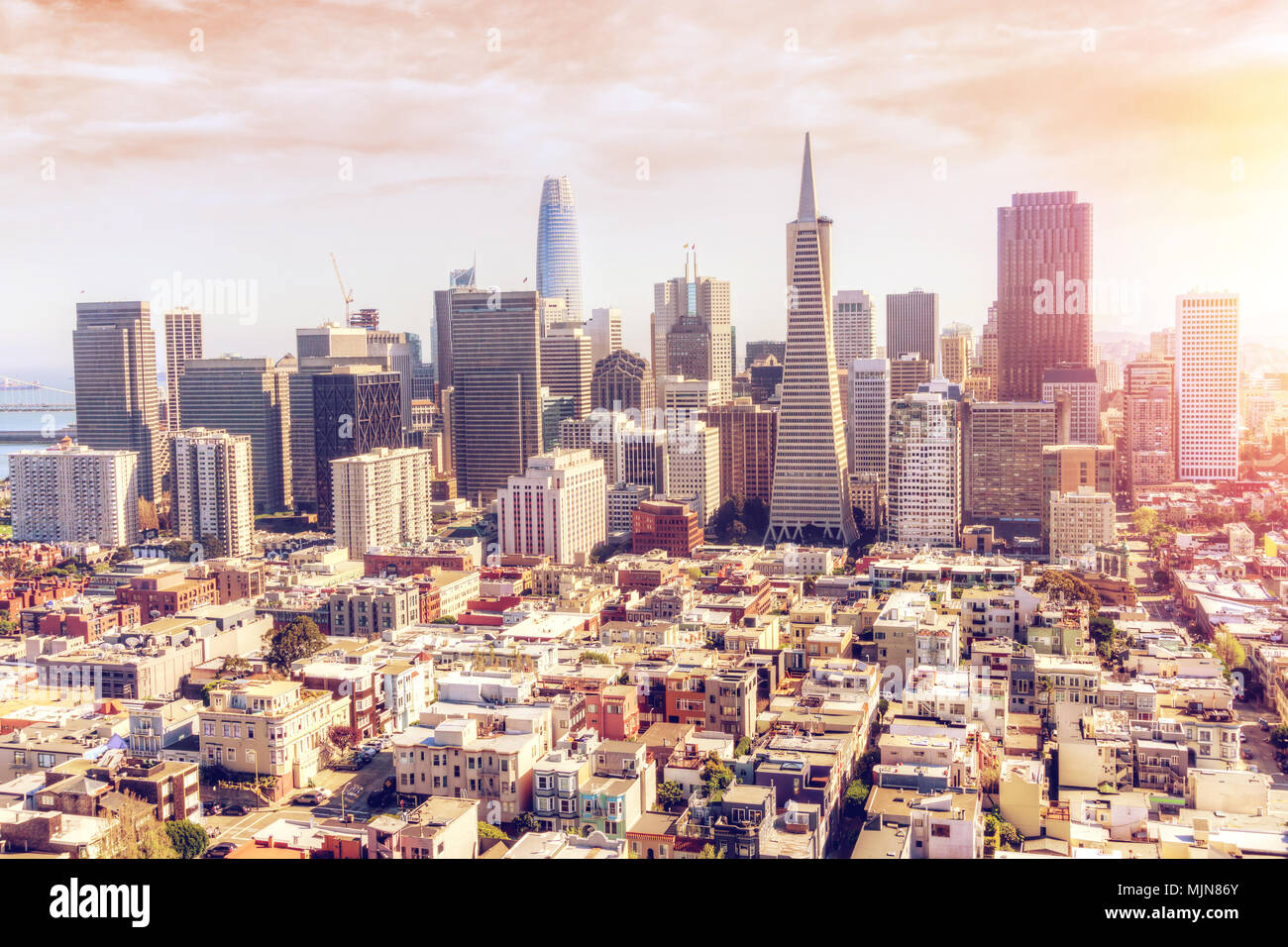 Aerial View of late afternoon golden sunset over San Francisco downtown skyline showing the financial district and tall skyscrapers with deliberate le Stock Photo