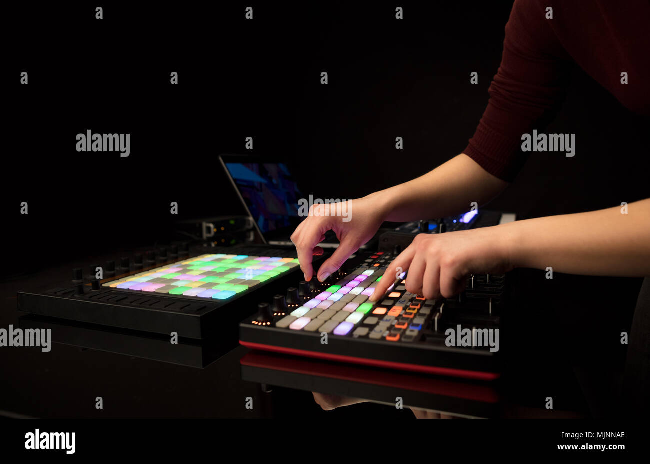 Midi Controller Hand Dj hand remixing music on midi controller Stock Photo - Alamy