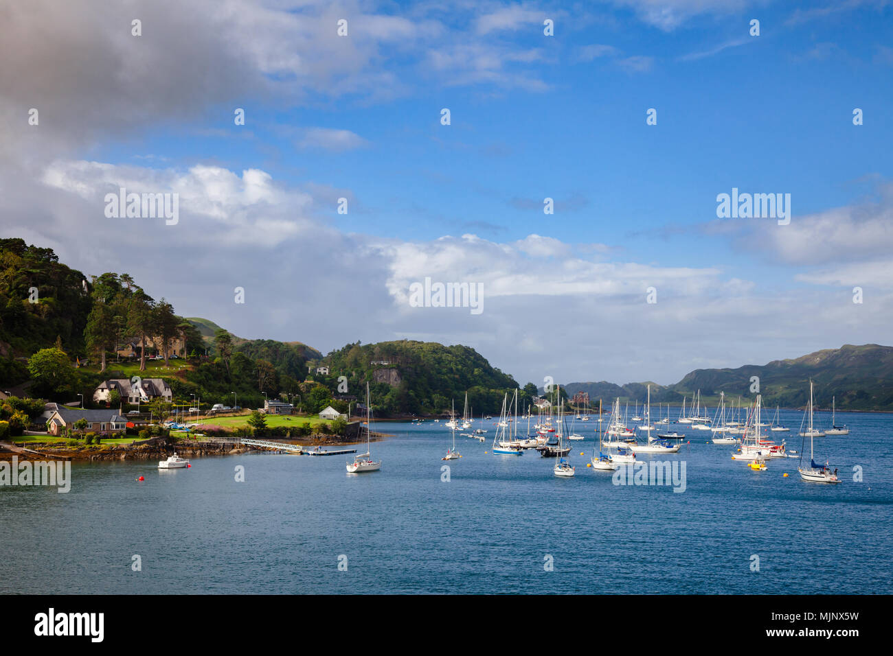 Seaside houses and anchored sailboats at Oban Bay. Oban is popular a resort town and ferry terminal in Argyll and Bute, Scotland, UK, Stock Photo