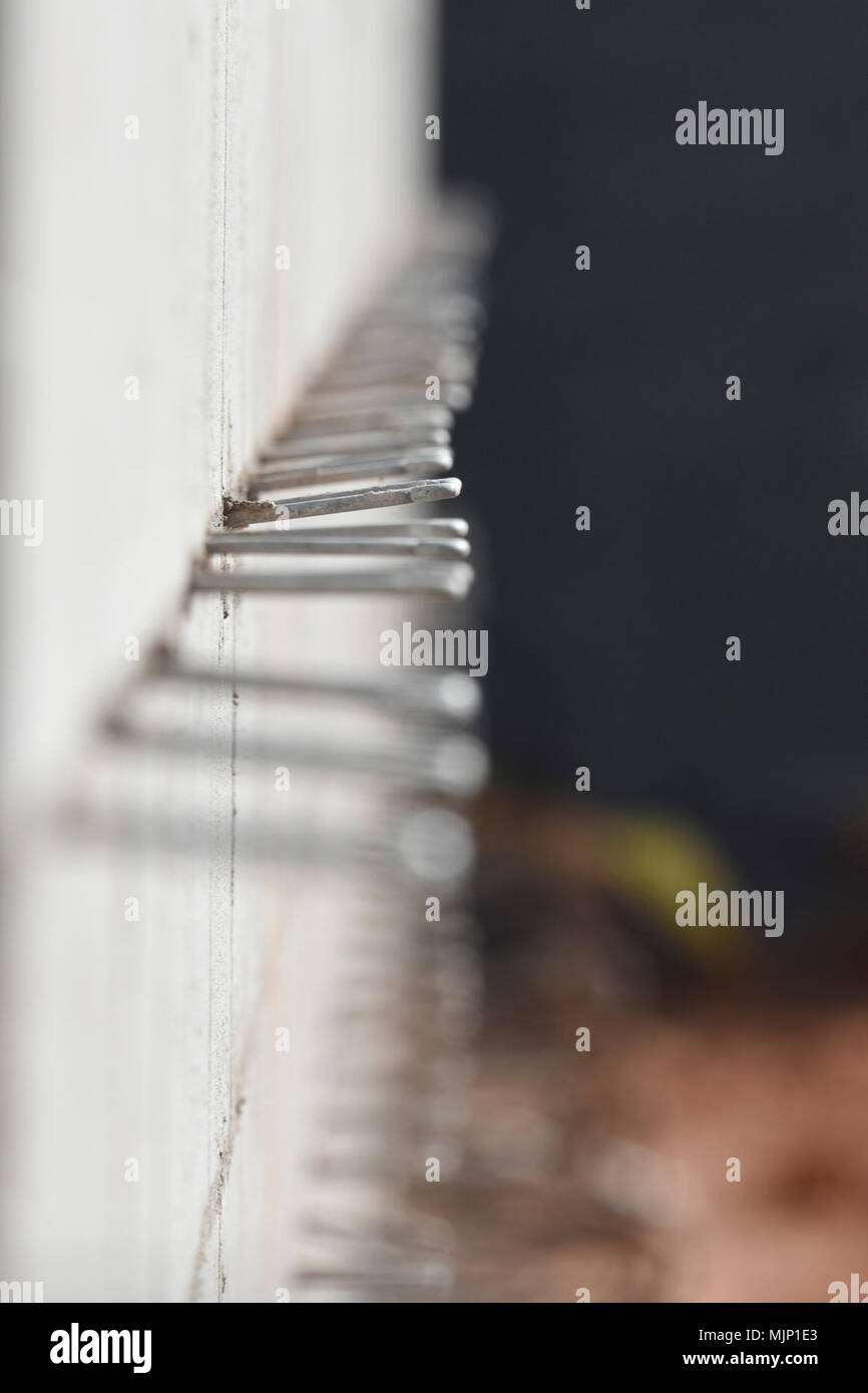 Anchors protrude from the mortar of a cinderblock wall in the KC46 'Pegasus' tanker maintenance