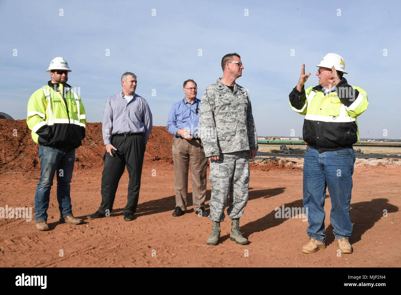 A contractor explains the process for erecting Tinker's new air traffic control tower to Lt. Col. Scott Denny, 72nd Operations Support Squadron commander, March 9, 2018, Tinker Air Force Base, Oklahoma. The new control tower will sit near the center of the airfield to provide controllers with a better vantage point and will incorporate modern technology and comforts. Armed Forces and civilians displaying courage bravery dedication commitment and sacrifice Stock Photo