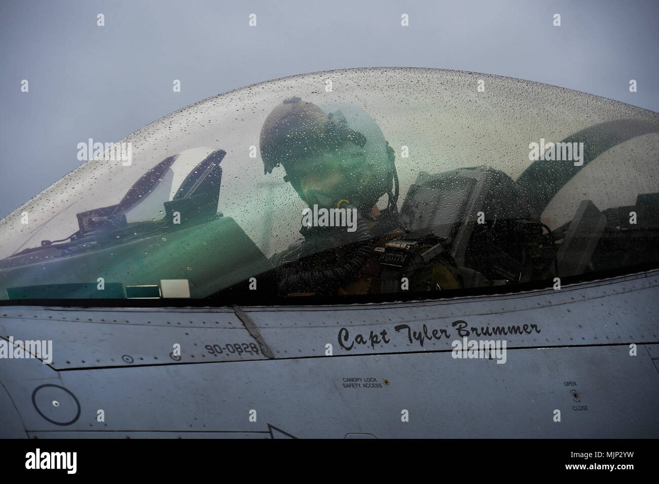 U.S. Air Force Capt. Tyler Brummer, 480th Fighter Squadron pilot, sits in his F-16 Fighting Falcon while receiving fuel during a Hot Pit exercise as part of a two-week exercise at Spangdahlem Air Base, Germany, Mar. 13, 2018. Brummer is one of many pilots who patrols the skies during the exercise to stay prepared for real world scenarios. Armed Forces and civilians displaying courage bravery dedication commitment and sacrifice Stock Photo
