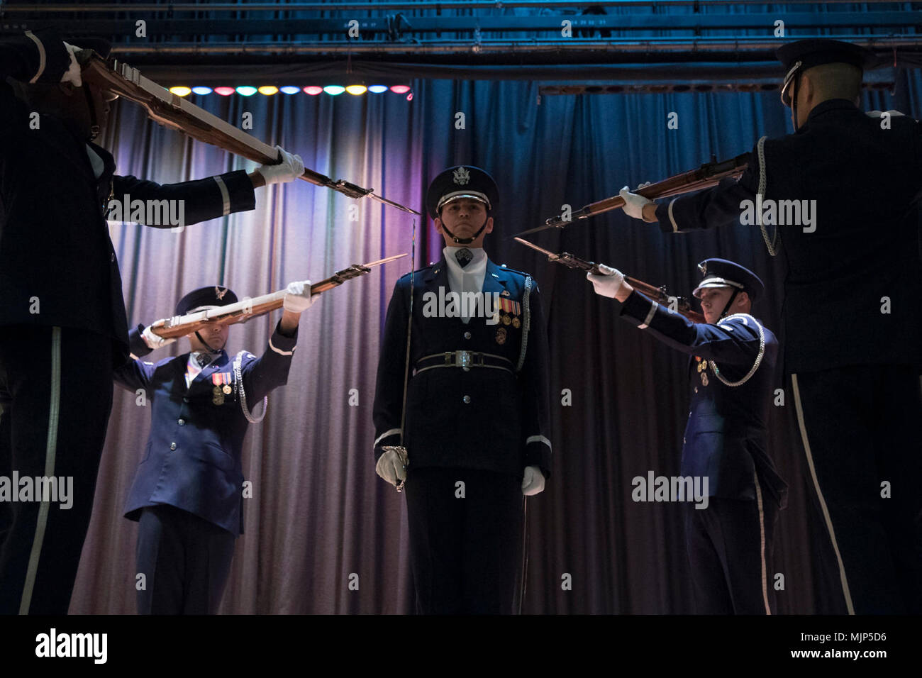 Capt. Riley Platt, U.S. Air Force Honor Guard support flight and drill team commander, stands at attention during a performance at Francis Lewis High School in Fresh Meadows, N.Y., March 16, 2018. Along with the drill performance, the team also did a colors presentation and a meet-and-greet with the students. Armed Forces and civilians displaying courage bravery dedication commitment and sacrifice Stock Photo