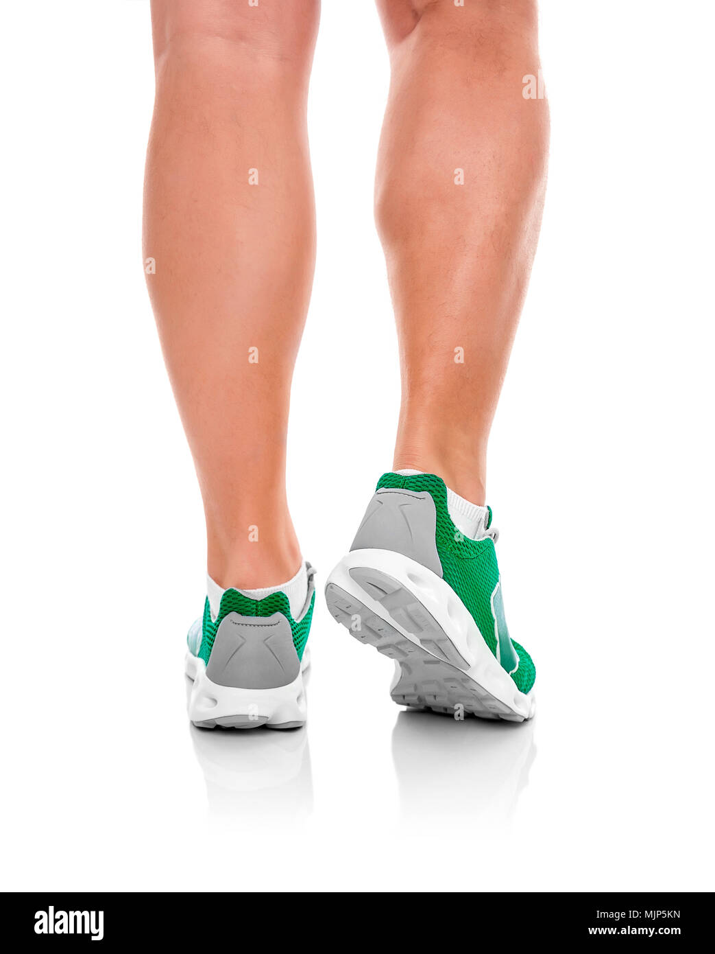 Male legs in sneakers over white. Stock Photo