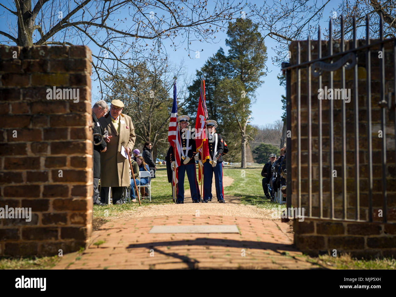 U.S. Marines with Marine Corps Base Quantico Color Guard prepare to enter the cemetery for the Presidential wreath laying ceremony held in honor of the 4th President of the United States, James Madison, also known as the Father of the Constitution, at his home at Montpelier, Orange, Va., March 16, 2018. This event was held in commemoration of the 267th anniversary of the birth of Madison, born in 1751, and has also been decreed as James Madison Appreciation Day for the Commonwealth of Virginia. Armed Forces and civilians displaying courage bravery dedication commitment and sacrifice Stock Photo