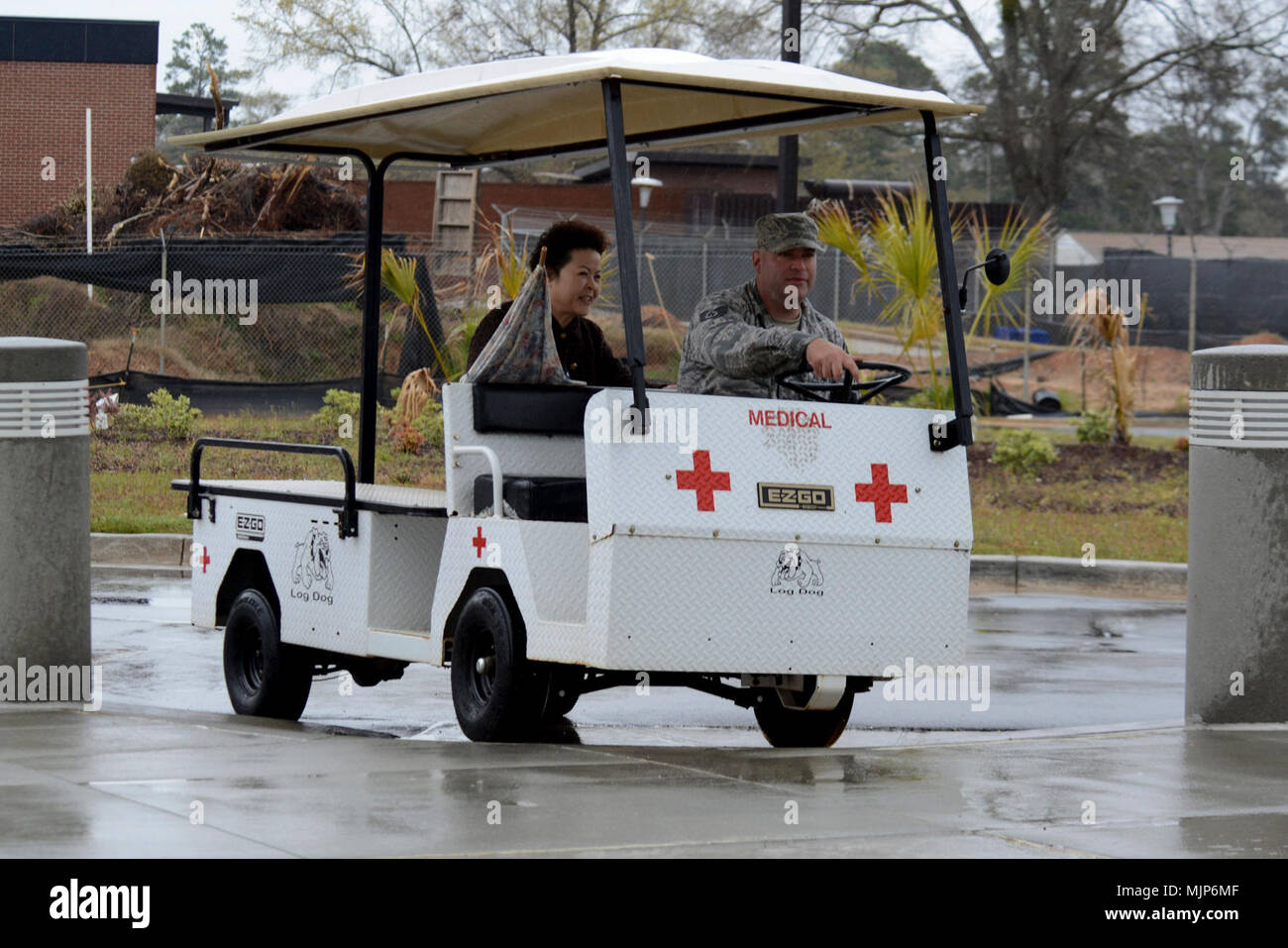 U.S. Air Force Tech. Sgt. Brian Londo, 20th Medical Group (MDG) medical logistics warehouse noncommissioned officer in charge, drives a Team Shaw member to the 20th MDG clinic using the patient shuttle golf cart at Shaw Air Force Base, S.C., March 19, 2018.  The 20th MDG golf cart brings patients from their car to the front entrance of the clinic. Armed Forces and civilians displaying courage bravery dedication commitment and sacrifice Stock Photo