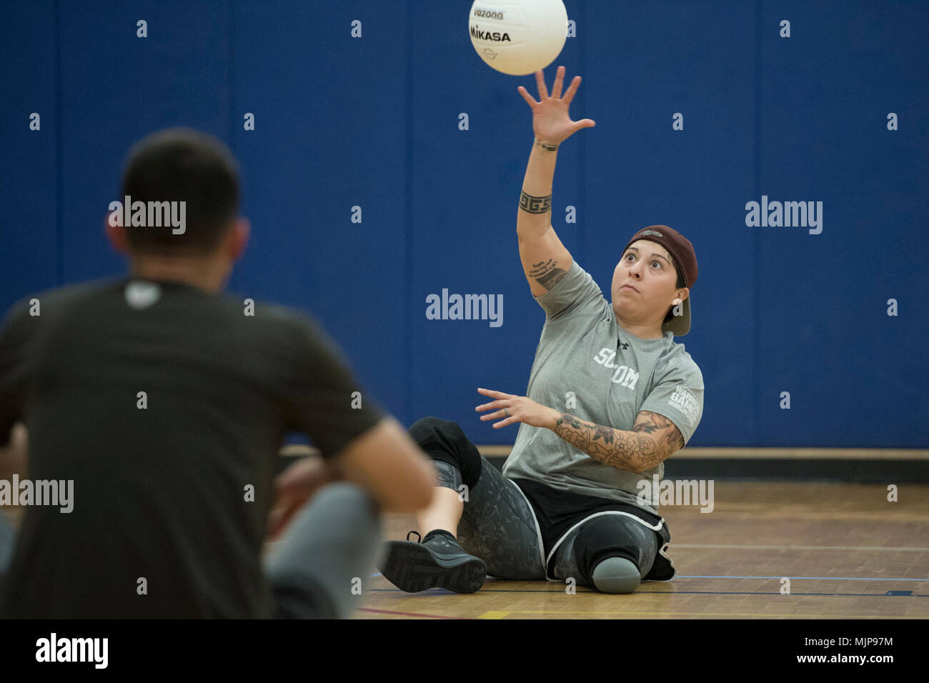 USSOCOM's Army Sgt. Lauren Montoya practices sitting volleyball during training for the 2018 DoD Warrior Games at MacDill Air Force Base in Florida on March 20, 2018.  Participation in USSOCOM Warrior Care Program military adaptive sport events throughout the year enhances SOF athletes' mental and physical rehabilitation, aiding in their reintegration or transition.    (DoD Armed Forces and civilians displaying courage bravery dedication commitment and sacrifice Stock Photo