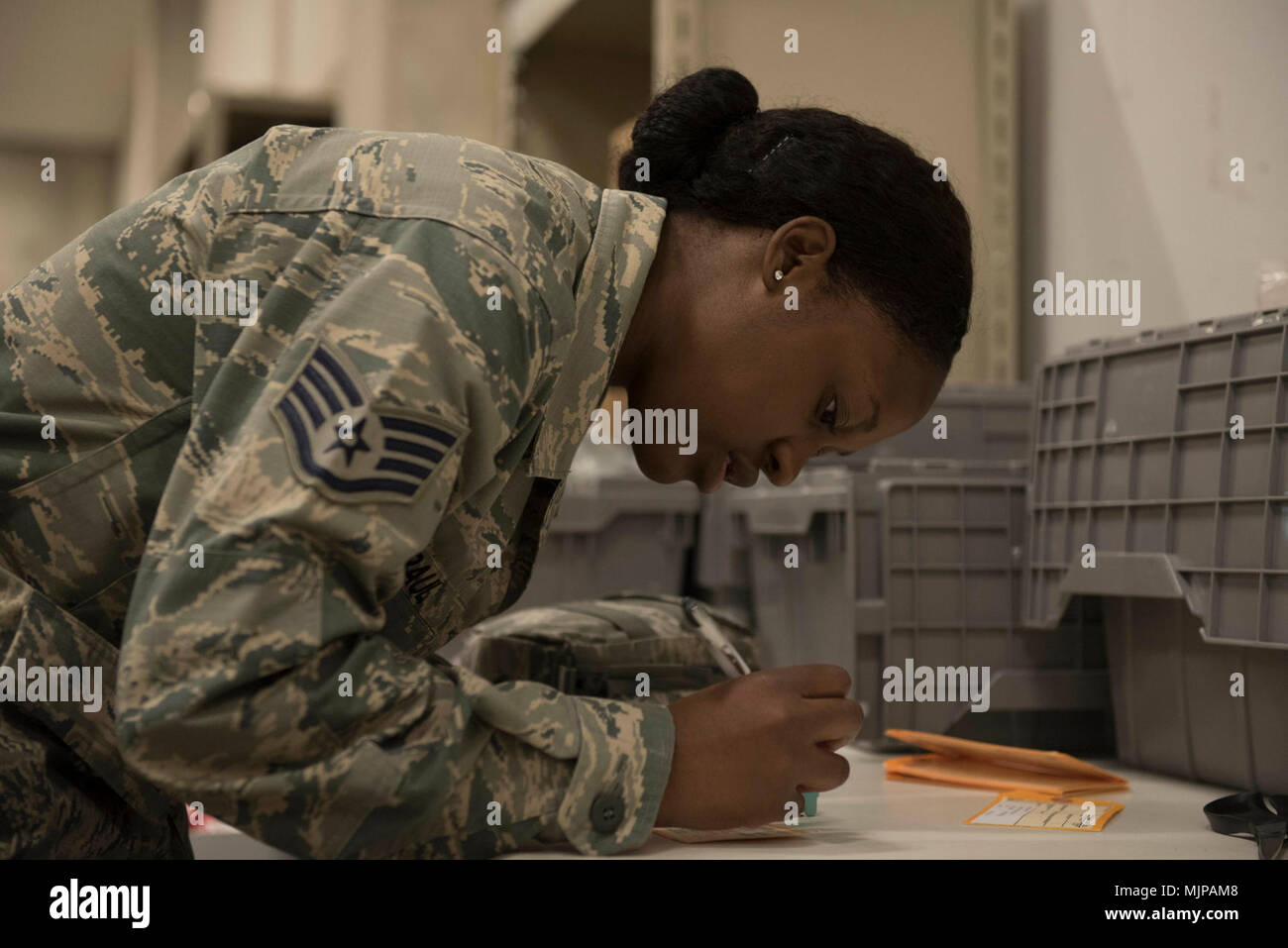 U.S. Air Force Staff Sgt. Sha’leah Paul, 18th Medical Group medical material technician, signs off on the contents of a first-aid kit March 21, 2018, at Kadena Air Base, Japan. Medical materials go through the warehouse managed by the 18th MDG “Log Dogs” before being distributed throughout units both in and outside the medical group building. Armed Forces and civilians displaying courage bravery dedication commitment and sacrifice Stock Photo