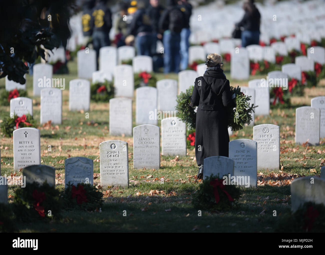 Participants lay wreaths during Wreaths Across America at Arlington