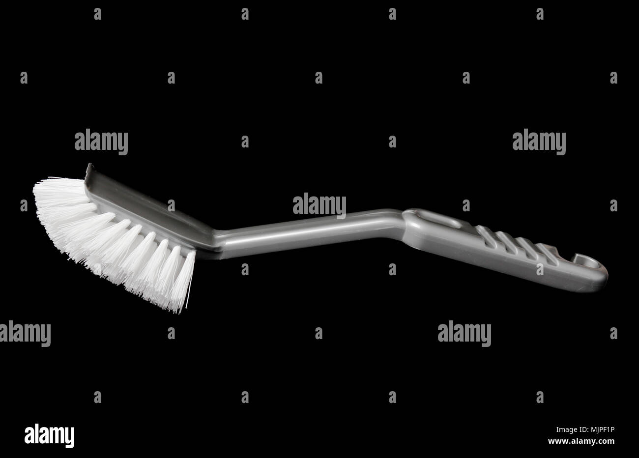 Grey  dish  brush isolated on black background. Stock Photo