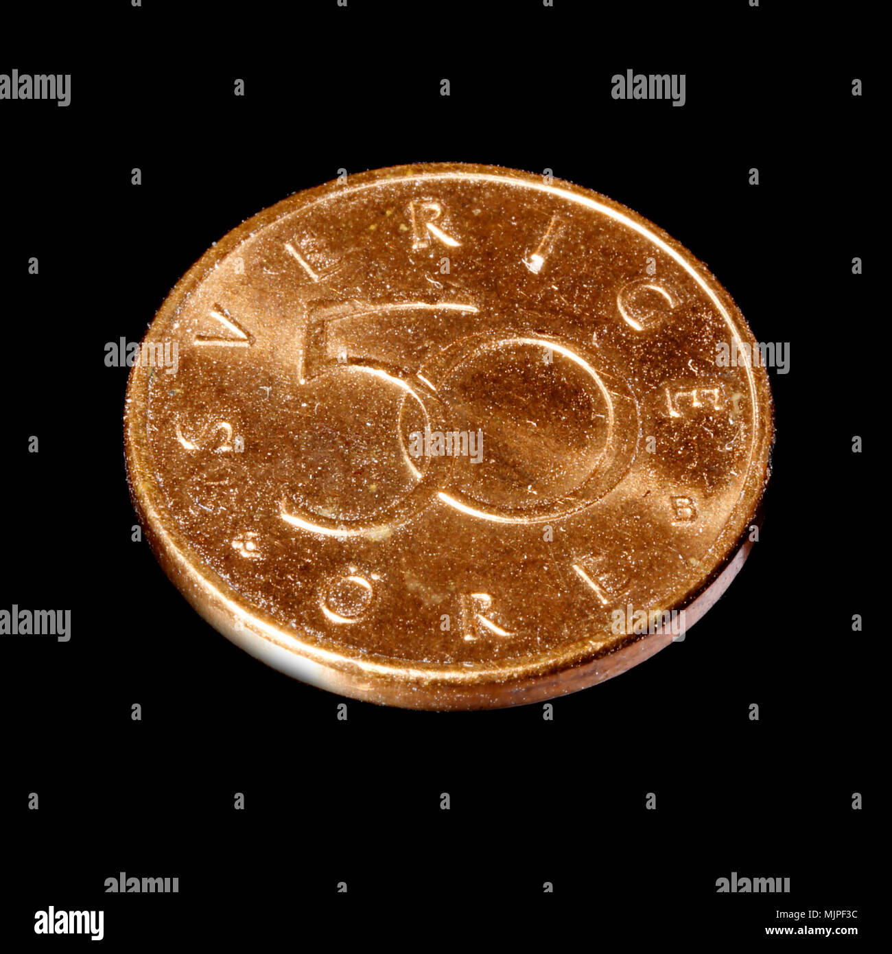 Swedish 50 ore denomination bronze coin in service 1992-2009 isolated on black background. Stock Photo