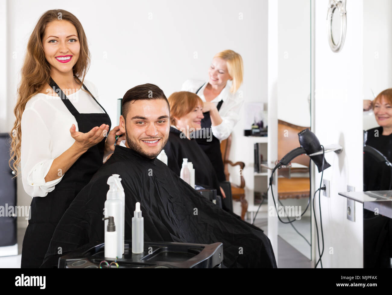 Happy Young Guy Cuts Hair At The Hair Salon Stock Photo 183662498