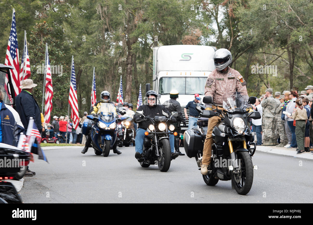 Motorcyclists participate in one of two police escorts for trucks