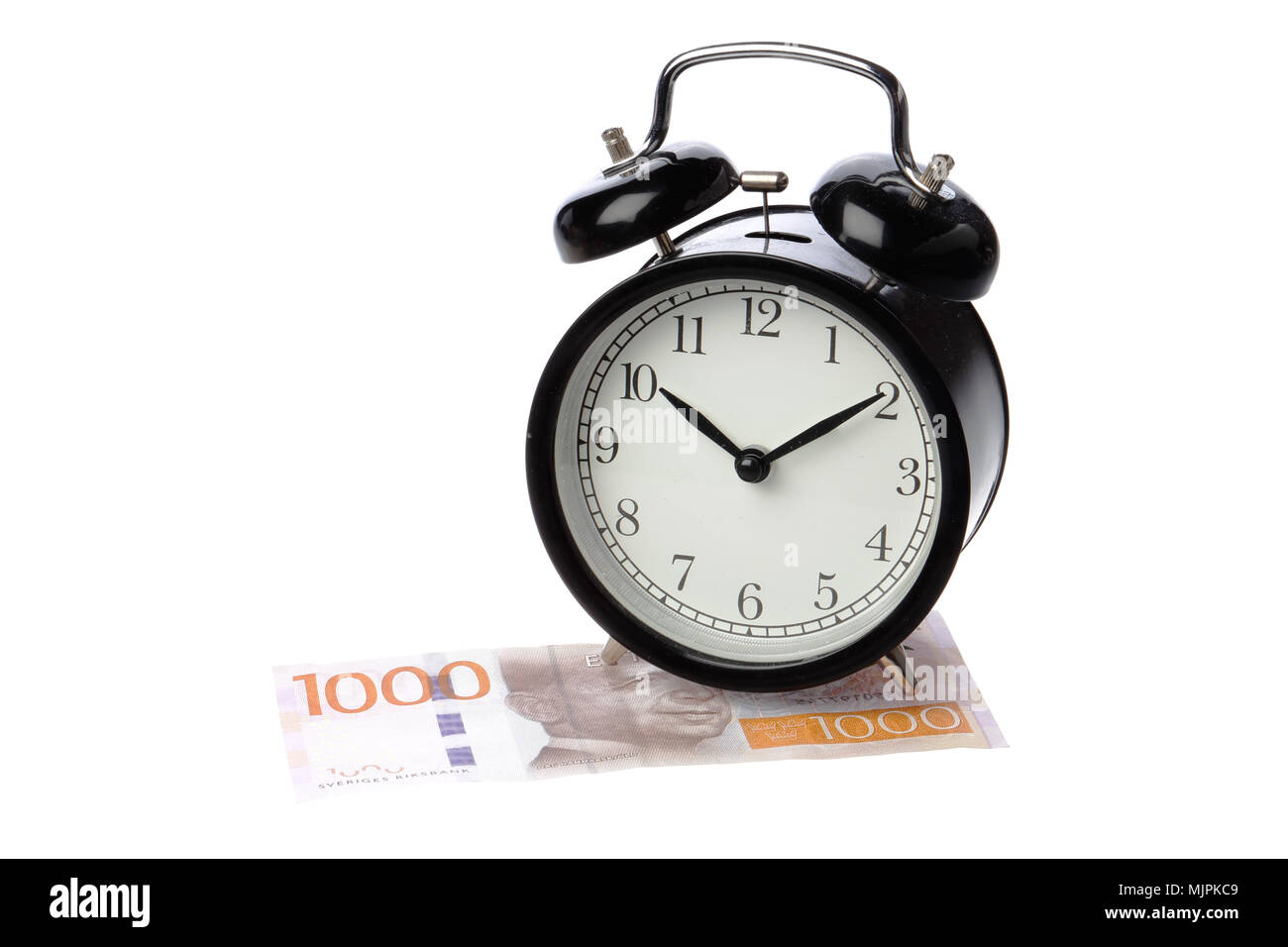 One black alarm clock on a Swedish 1000 krona banknote isolated on white background. Stock Photo