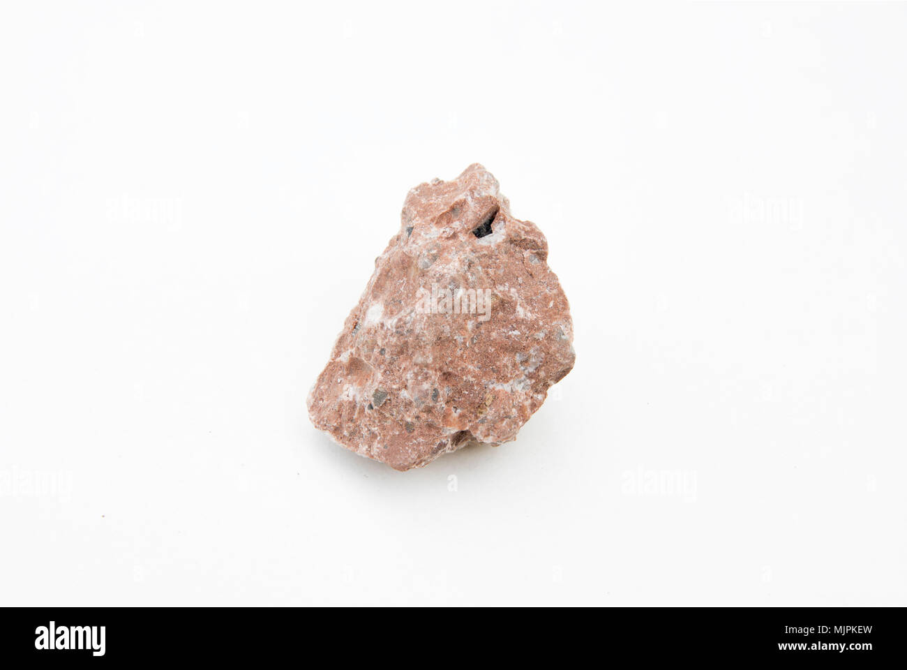 extreme close up with a lot of details of breccia rock isolated over white background Stock Photo