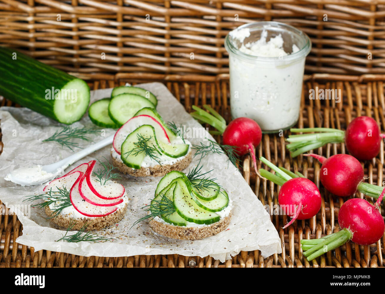 Variety of mini sandwiches with cream cheese, radish , cucumber, dill and spices. Picnic snacks