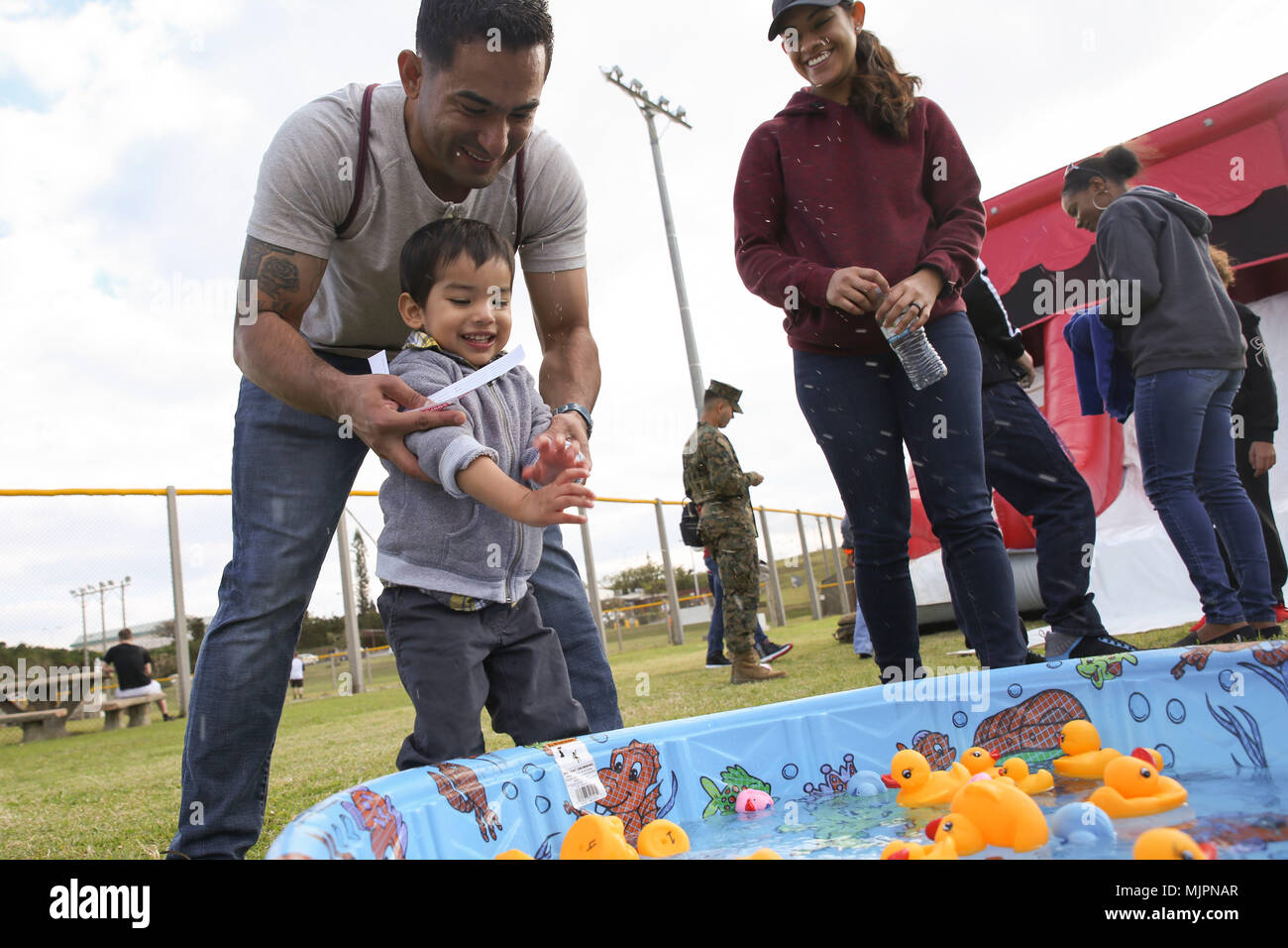 Alexander, 2, makes a splash in a rubber duck game during the third annual  Reindeer Games Dec. 22, 2017 at Camp Kinser, Okinawa, Japan. Alexander's  father, Staff Sgt. Gabriel Deandas, is the