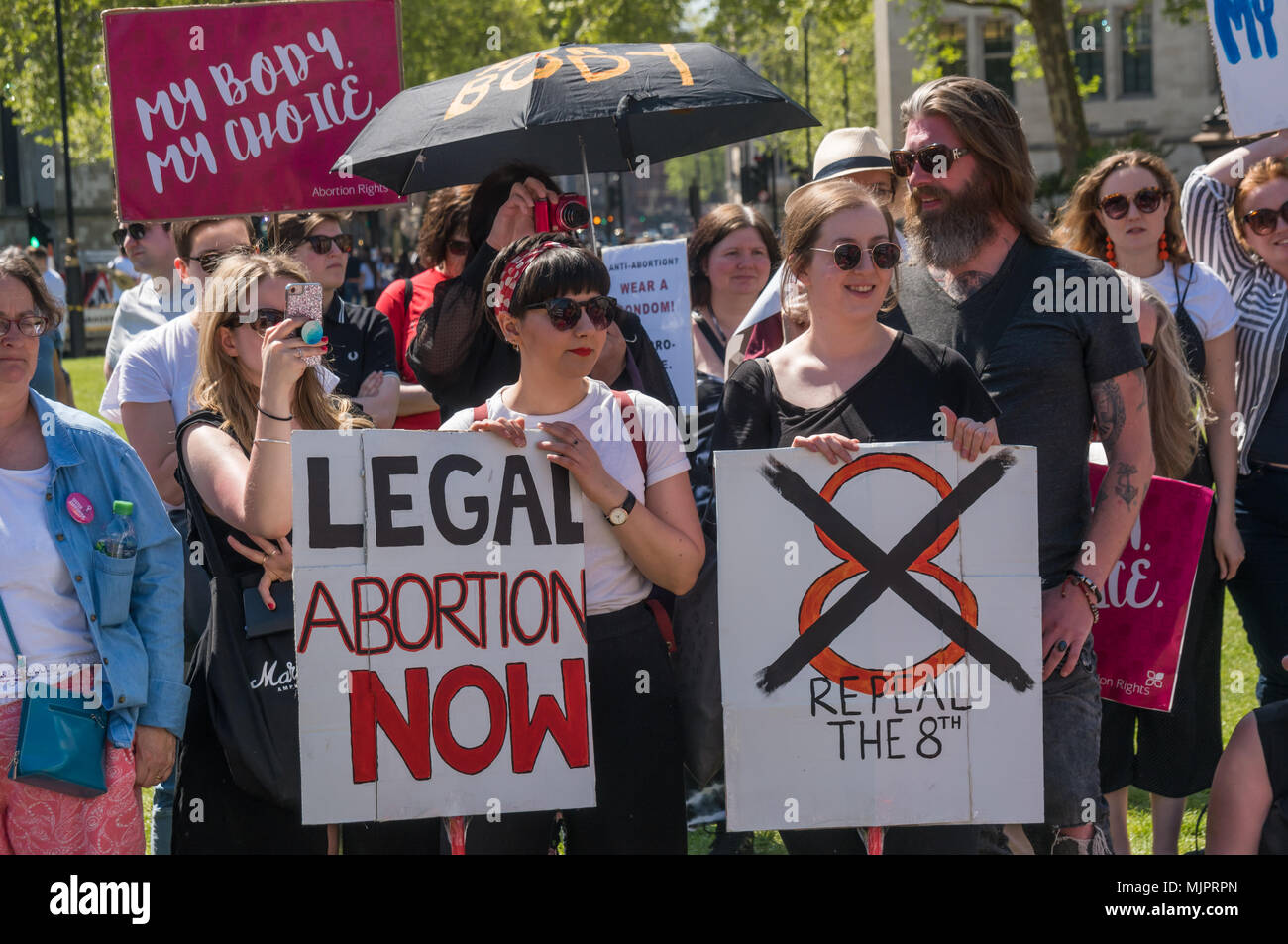 London, UK. 5th May 2018. Women in the abortion rights campaign hold posters calling for the repeal of the Irish 8th amendment against abortion at a rally in Parliament Square before the annual March for Life UK by pro-life anti-abortion campaigners was to march to a rally there. They insisted on the right for women to choose and opposed to any increase of restrictions which would lead to the problems we saw before the 1967 Abortion Act, when women risked their lives in back street abortions. They called for an end of the harassment of women going into clinics, and for women in Northern Irelan Stock Photo