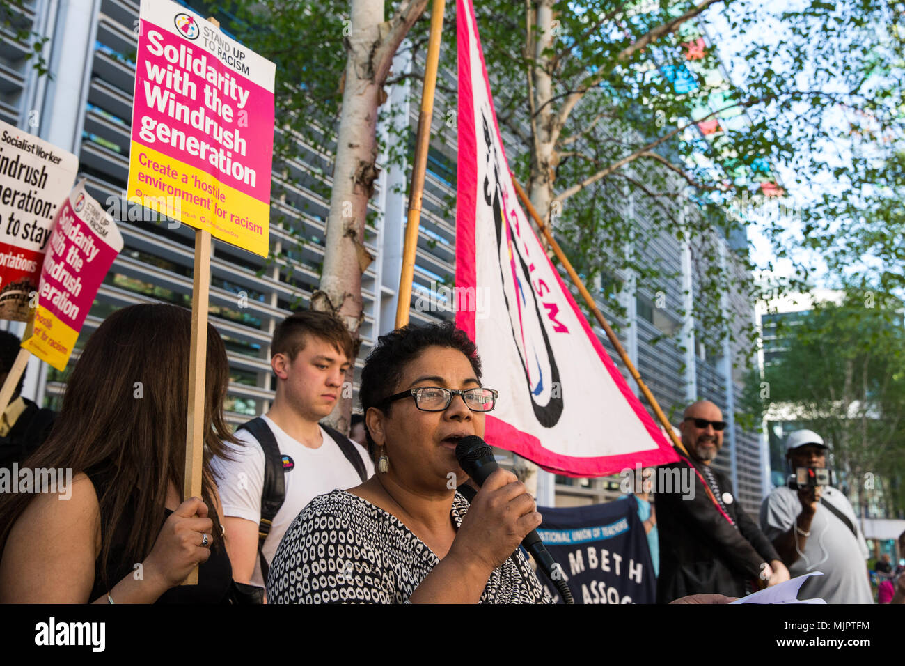London, UK. 5th May, 2018. An immigration lawyer reads her poem about Windrush to activists from Stand Up To Racism and supporters of the Windrush generation protesting outside the Home Office to call for the scrapping of the 2014 Immigration Act. Credit: Mark Kerrison/Alamy Live News Stock Photo
