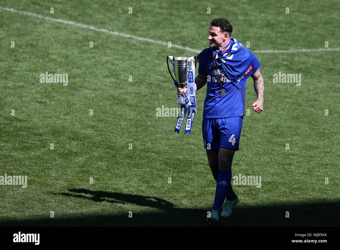 Cardiff, UK, 6 May 2018. Sean Morrison, the Cardiff city captain holds the trophy at the end of the match as he celebrates Cardiff's promotion to the Premier league. EFL Skybet Championship match, Cardiff City v Reading at the Cardiff City Stadium on Sunday 6th May 2018.  this image may only be used for Editorial purposes. Editorial use only, license required for commercial use. No use in betting, games or a single club/league/player publications. pic by  Andrew Orchard/Andrew Orchard sports photography/Alamy Live news Stock Photo