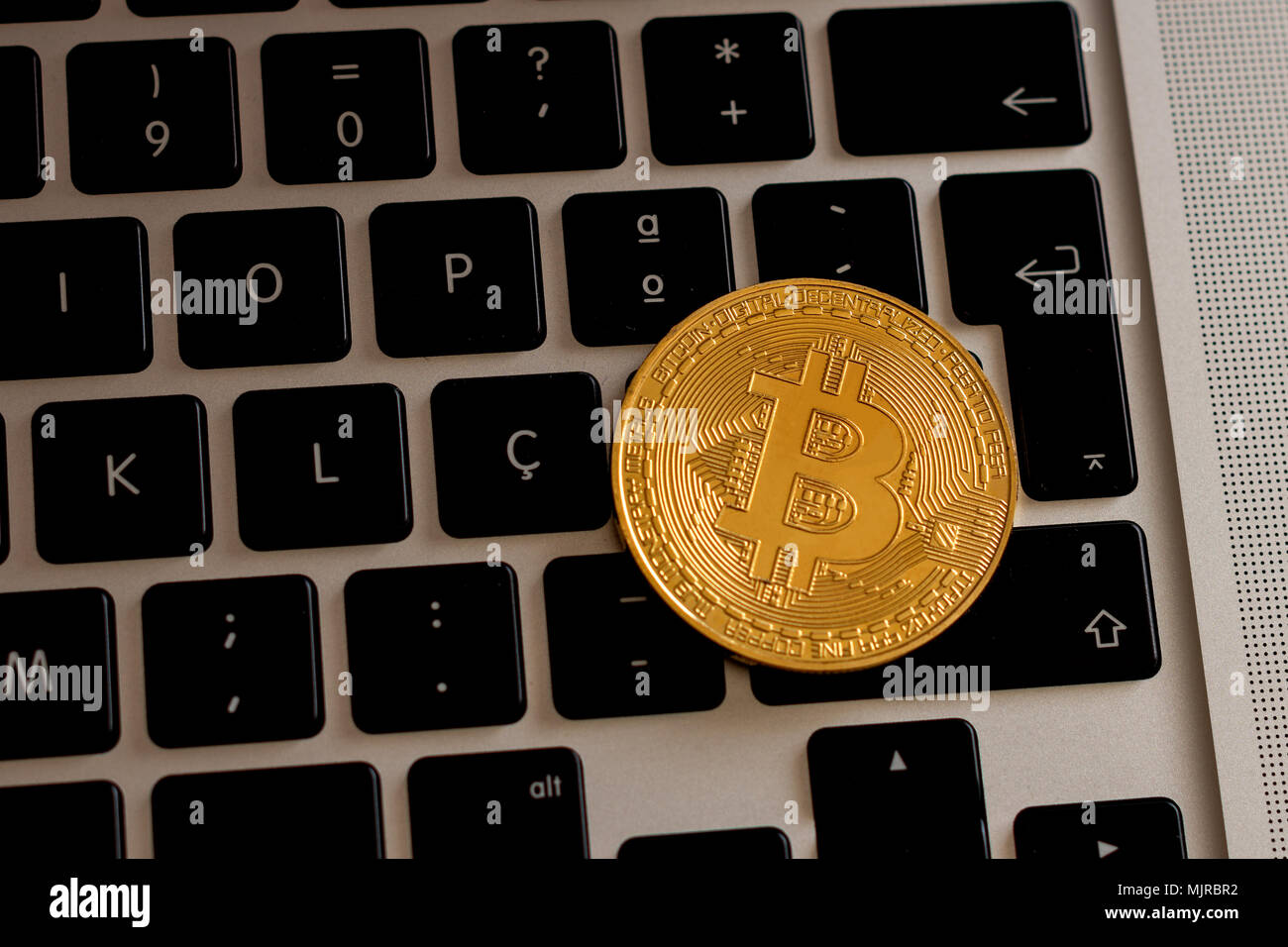 Bitcoin cryptocurrency coin over a laptop's keyboard Stock Photo - Alamy