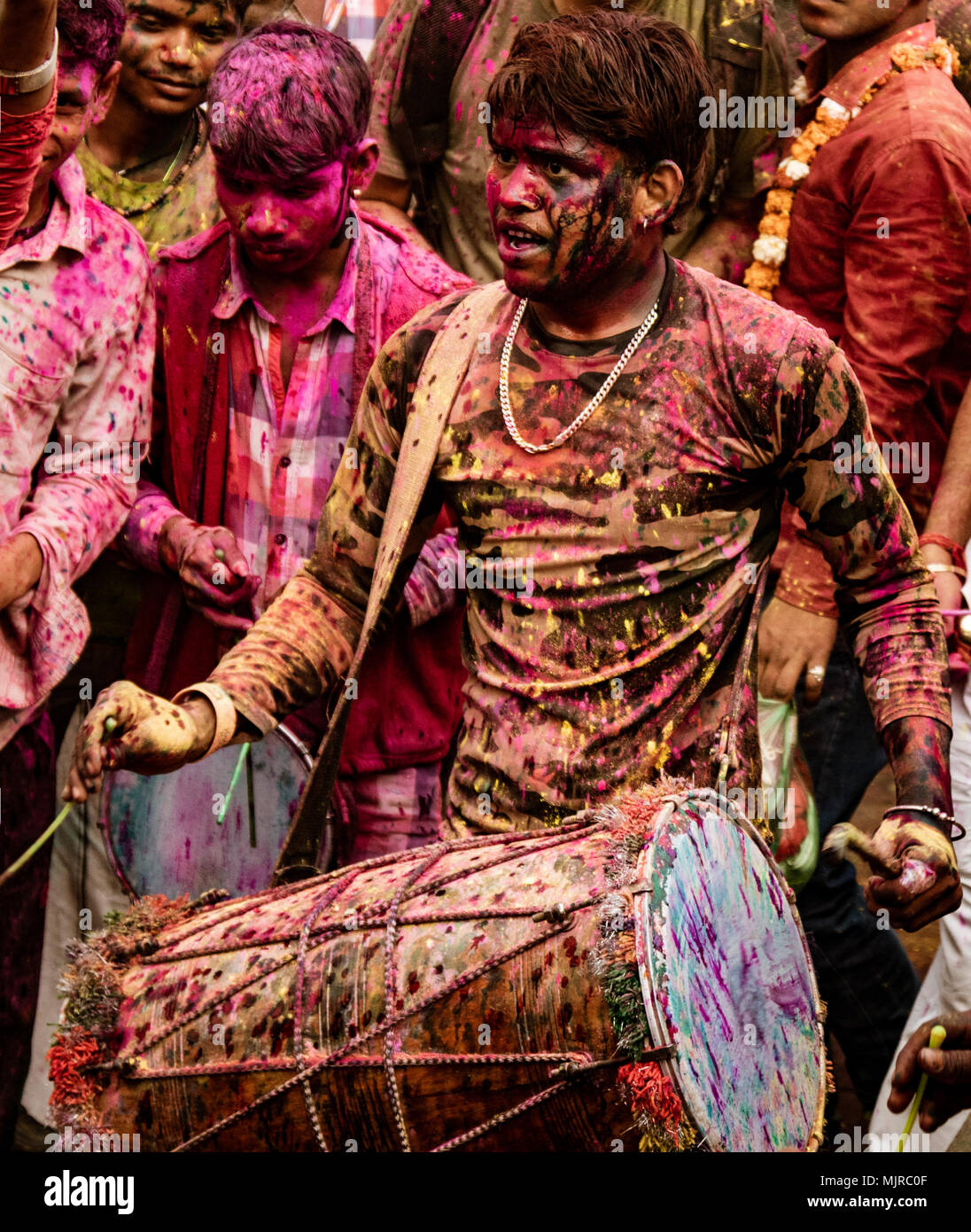 Barsana, India, Holi Festival, Feb 24, 2018 - Young man beats drum to provide music for Holi Festival in India Stock Photo