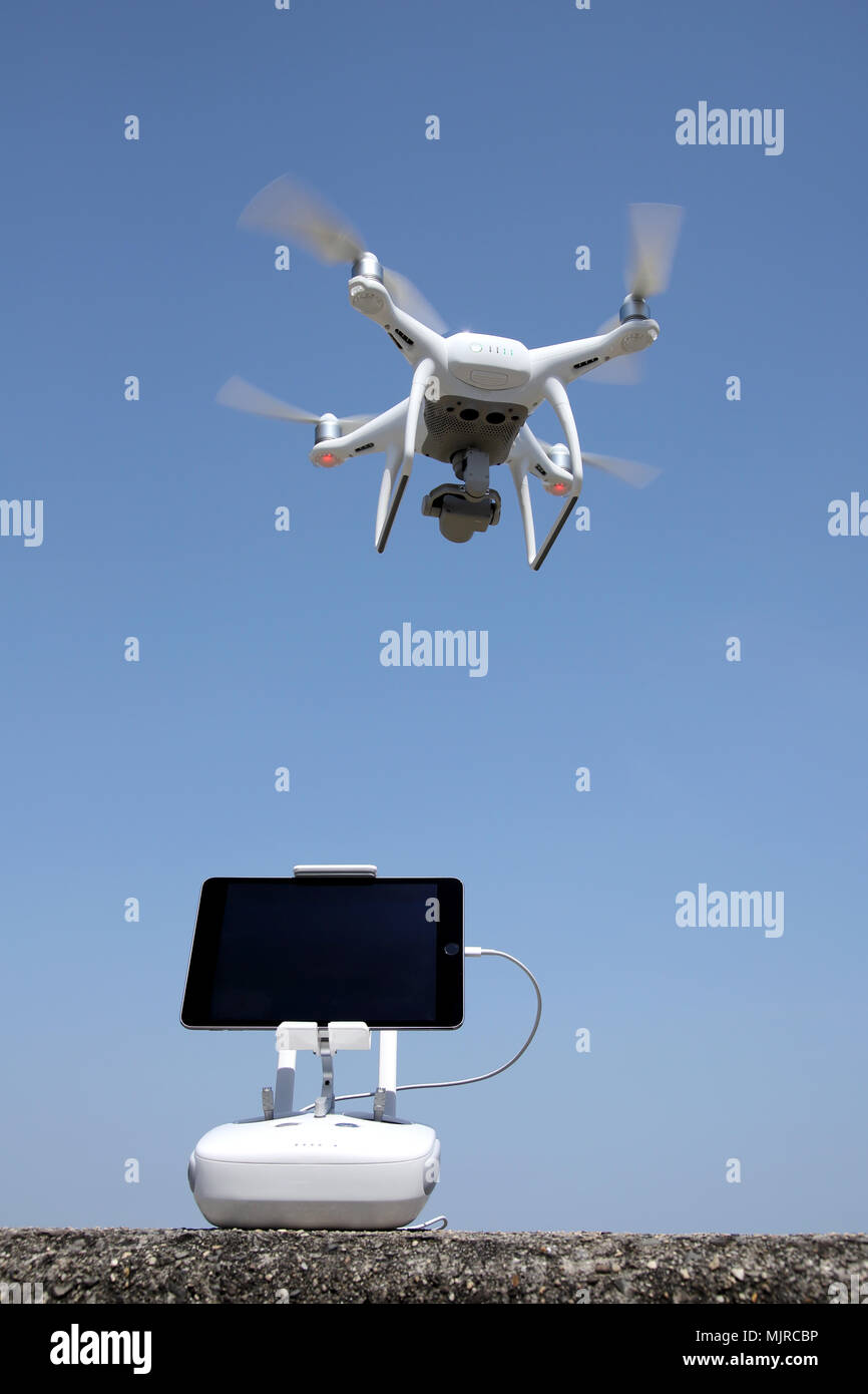 drone and remote controller, clear blue sky background Stock Photo