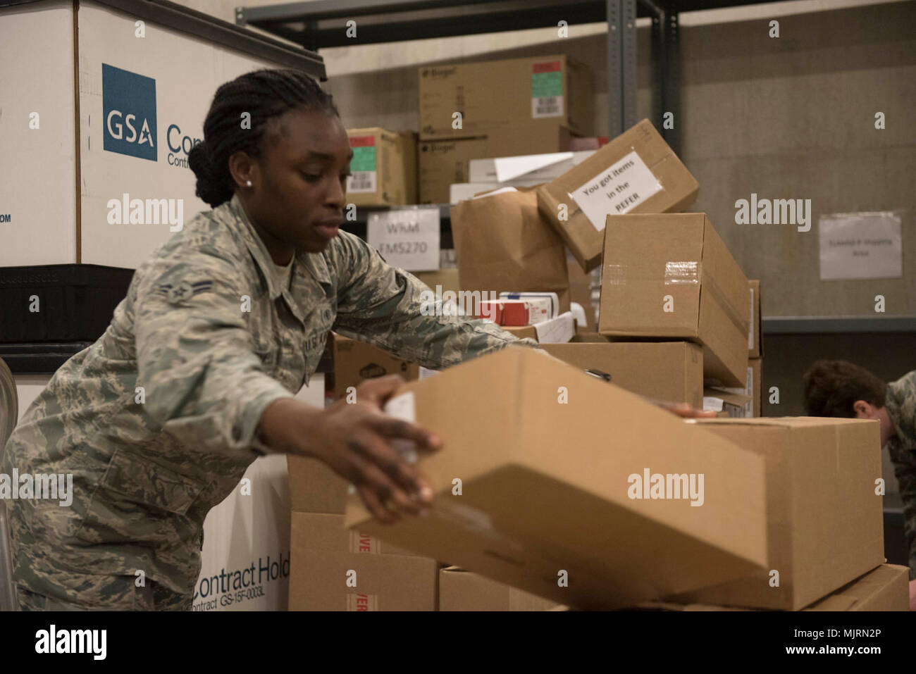 U.S. Air Force Airman 1st Class Ashley Cromwell, 18th Medical Group medical material technician, stacks boxes of medical supplies March 21, 2018, at Kadena Air Base, Japan. Medical materials go through the warehouse managed by the 18th MDG “Log Dogs” before being distributed throughout units both in and outside the medical group building. Armed Forces and civilians displaying courage bravery dedication commitment and sacrifice Stock Photo