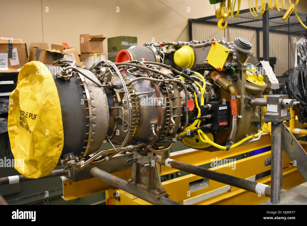 A brandnew engine awaits an AH64D Apache helicopter as Soldiers