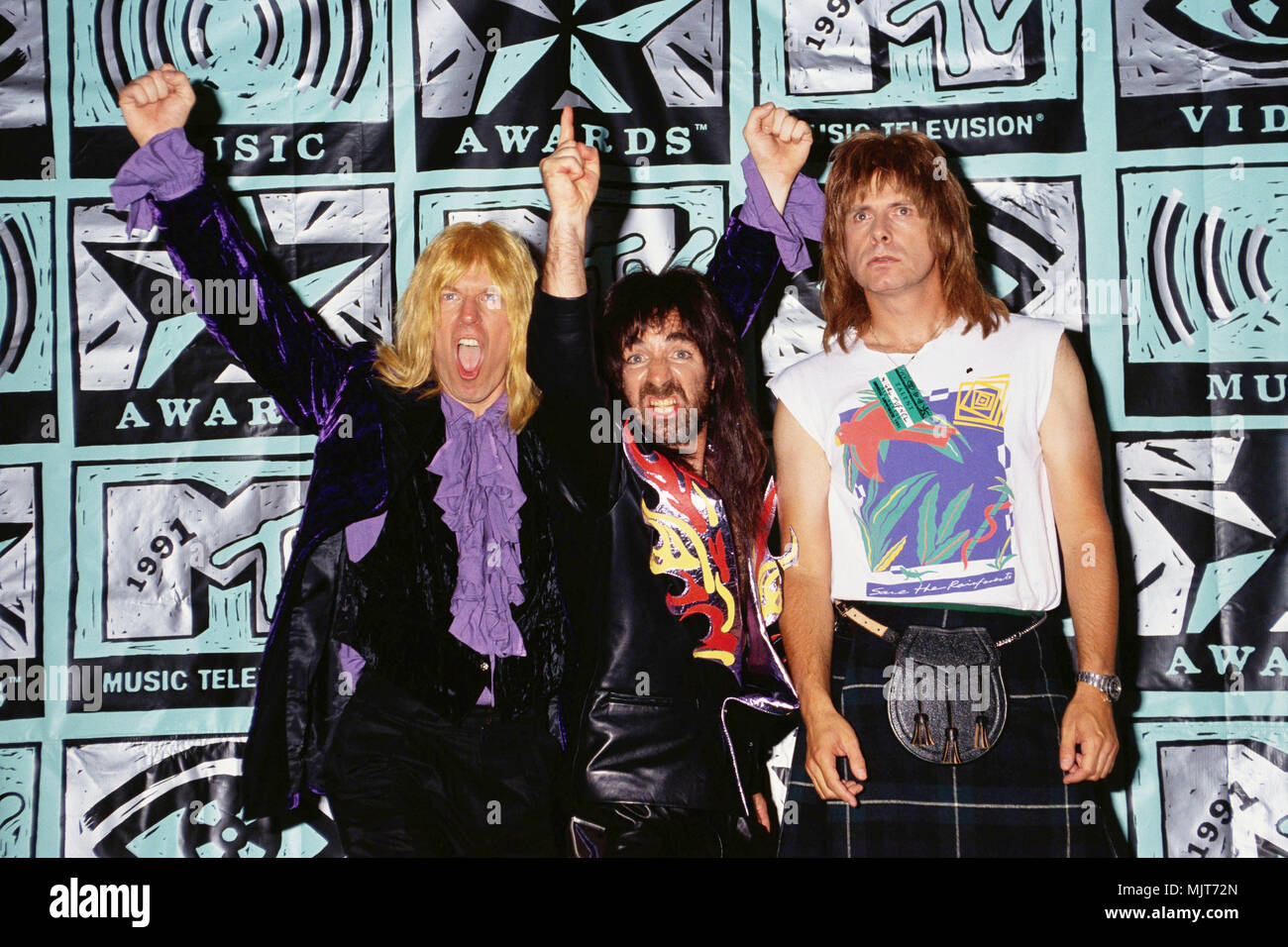 1991, USA --- The fictional rock band Spinal Tap attends the 1991 MTV Music Awards. Left to right: David St. Hubbins (Michael McKean), Derek Smalls (Harry Shearer), and Nigel Tufnel (Christopher Guest). --- ' Tsuni / USA 'Spinal Tap at MTV Music Awards Spinal Tap at MTV Music Awards inquiry tsuni@Gamma-USA.com Stock Photo