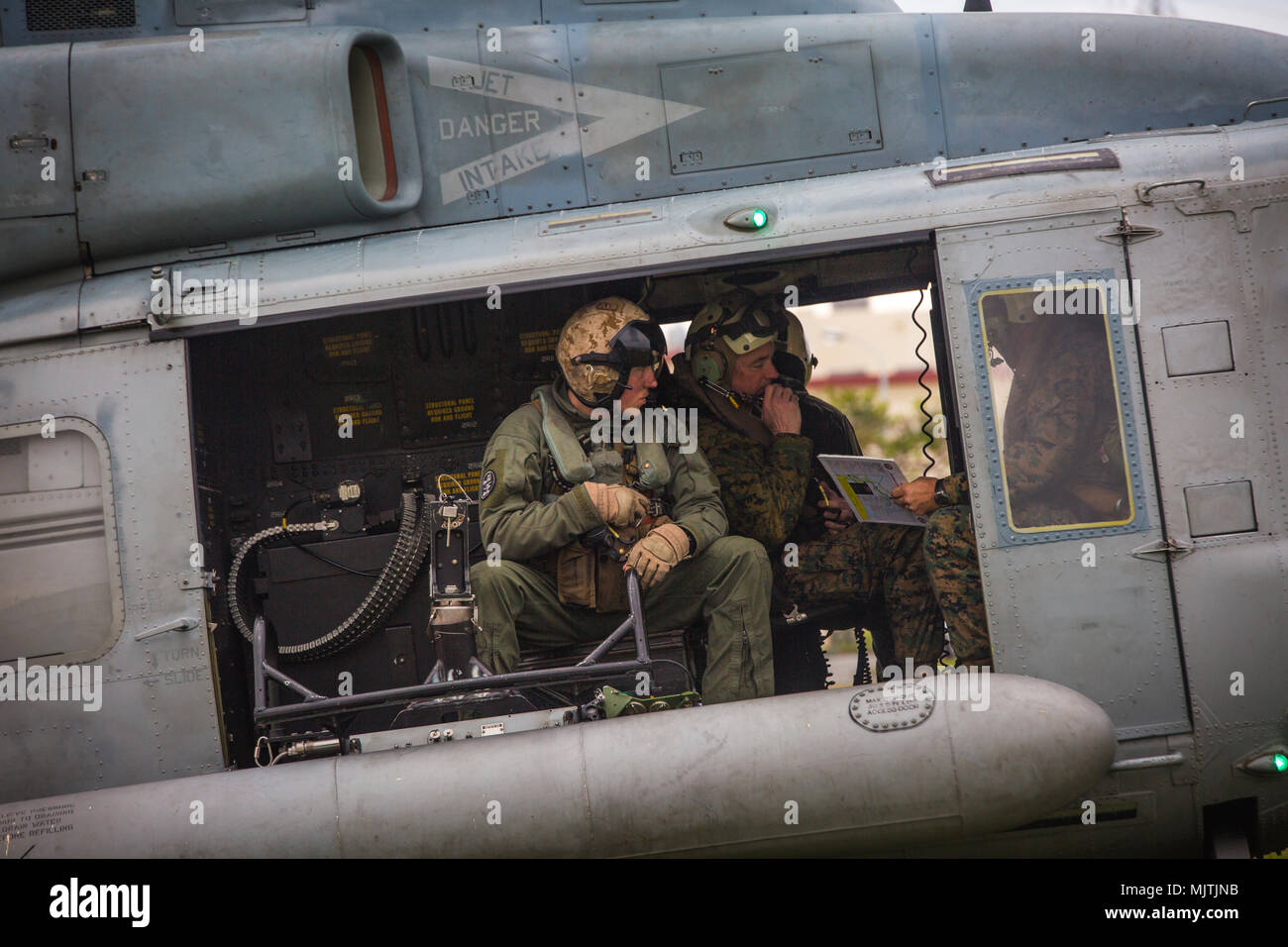 Lt. Gen. Brian D. Beaudreault, deputy commandant of plans, policies and operations, speaks to the UH-1Y Venom crew at Camp Foster, Okinawa, Japan, December 15, 2017. Marine Light Attack Helicopter Squadron 369 provided Beaudreault a flight around the Okinawa Prefecture to assess the service quality of the Marine Corps chowhalls. The “gunfighters’” readiness to act upon a moment’s notice is crucial to maintaining a stronger, more capable forward deployed force in the Indo-Asia-Pacific region. HMLA-369, Marine Aircraft Group 39, 3rd Marine Aircraft Wing, is currently forward deployed under the u Stock Photo