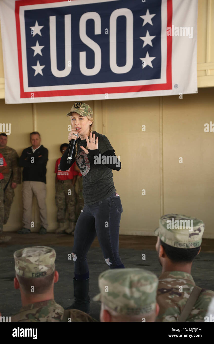 Comedian Iliza Shlesinger tells jokes to coaltion forces during the USO Holiday Tour 2017, at Camp Taji, Iraq, Dec. 25, 2017. Camp Taji is one of four Combined Joint Task Force – Operation Inherent Resolve building partner capacity locations dedicated to training partner forces and enhancing their effectiveness on the battlefield. (U.S. Army photo by Spc. Antonio Lewis) Stock Photo