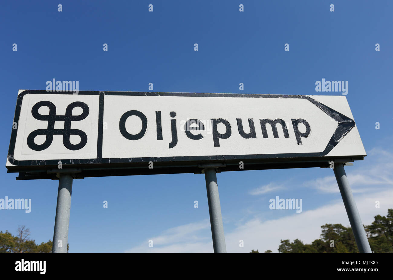 The sign shows the way to the attraction, oil pump in disused oil well in the Swedish province of Gotland. Stock Photo