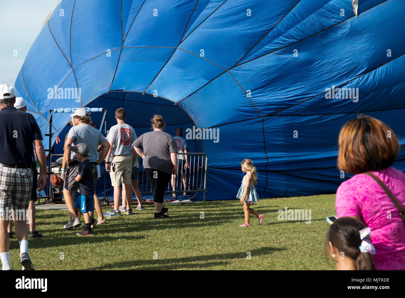 People lined up to walk inside a partially inflated hot air balloon at the 14th annual Hot Air Balloon Festival in Foley, Alabama. Stock Photo
