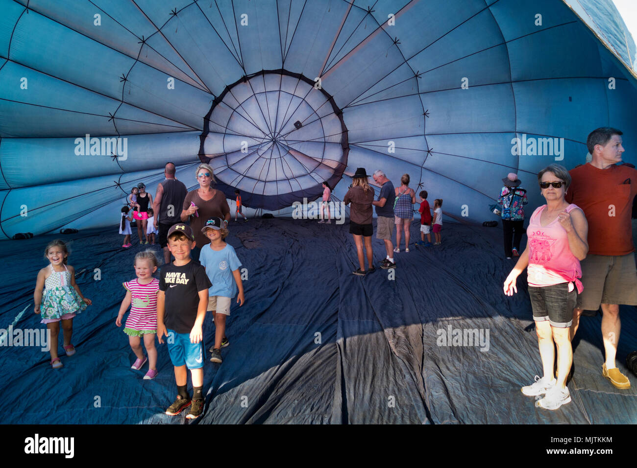 People exploring the inside of a partially inflated hot air balloon at the 14th annual Hot Air Balloon Festival at Foley, Alabama. Stock Photo